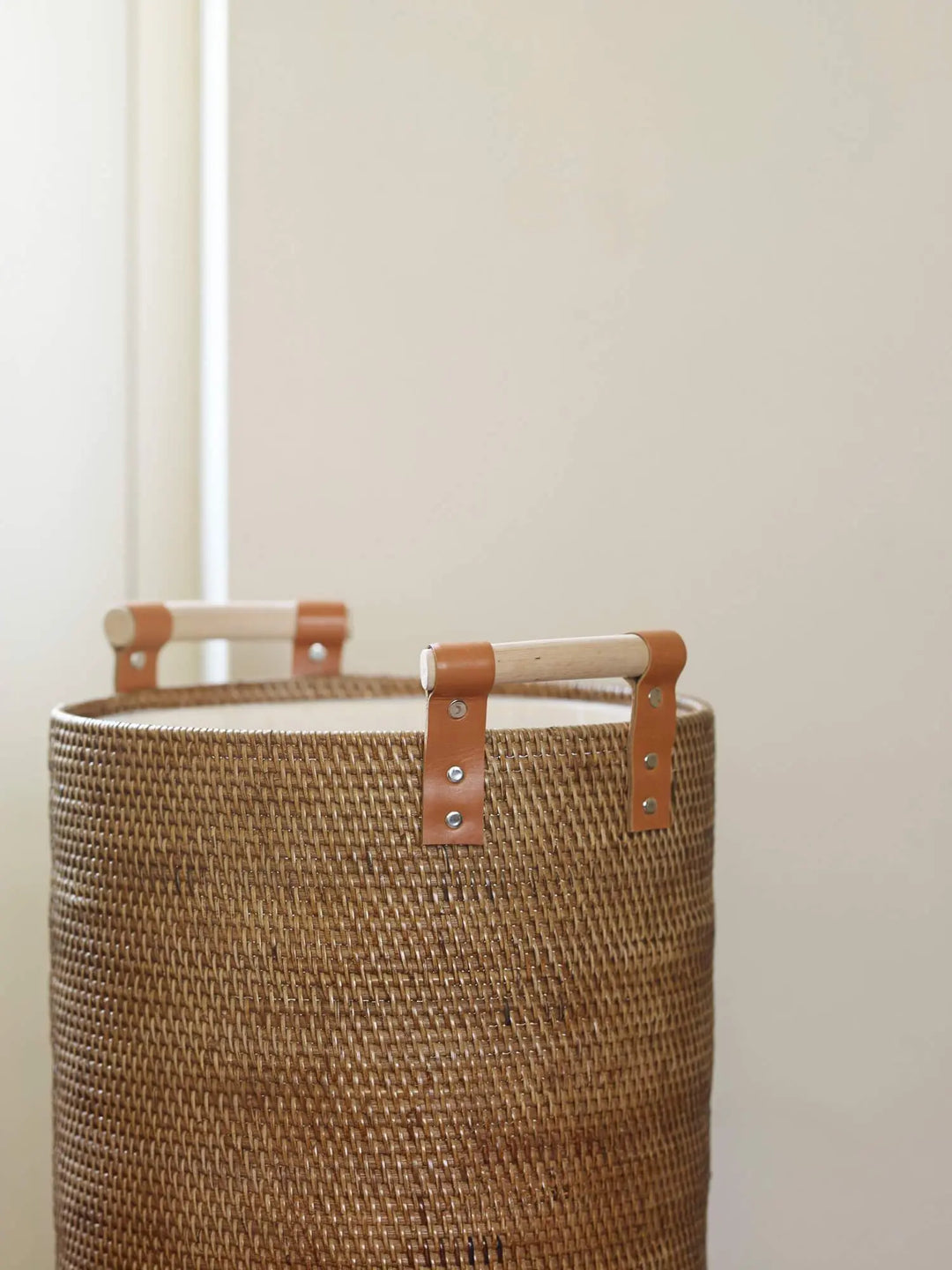 Beige vasketøjskurv i flet fra Aquanova med håndtag